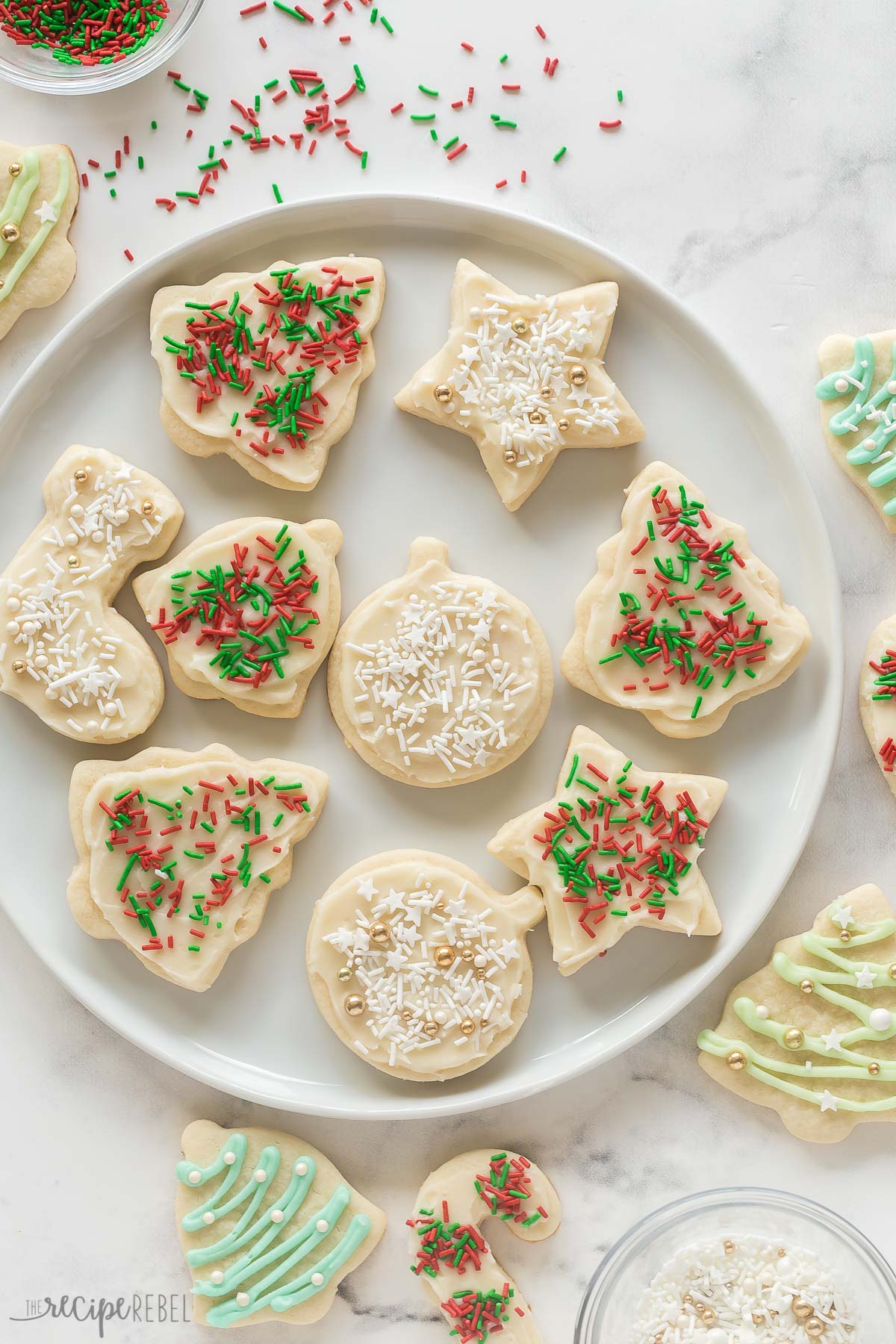 overhead image of christmas sugar cookies with white and red and green sprinkles