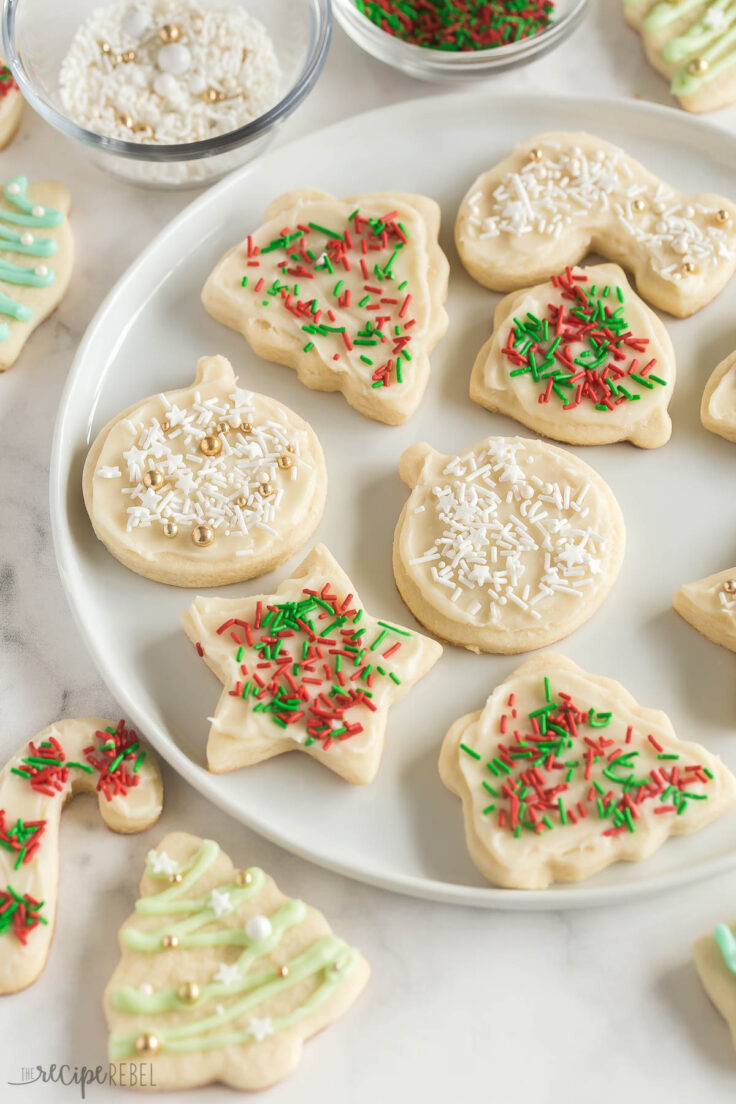 close up of christmas sugar cookies with white frosting and red and green sprinkles