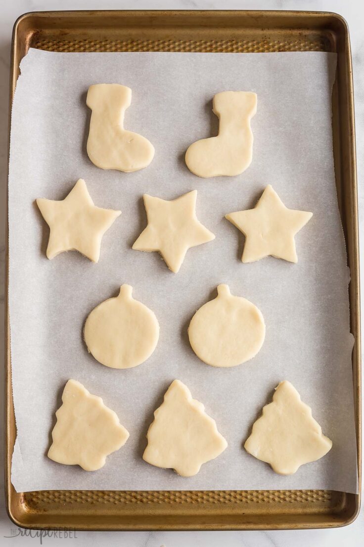unbaked sugar cookies on baking sheet with parchment paper
