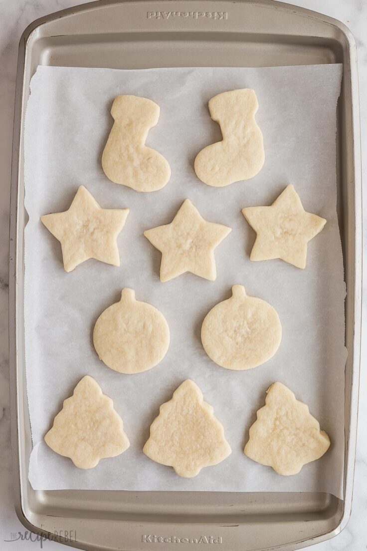 baked sugar cookies on baking sheet with parchment paper