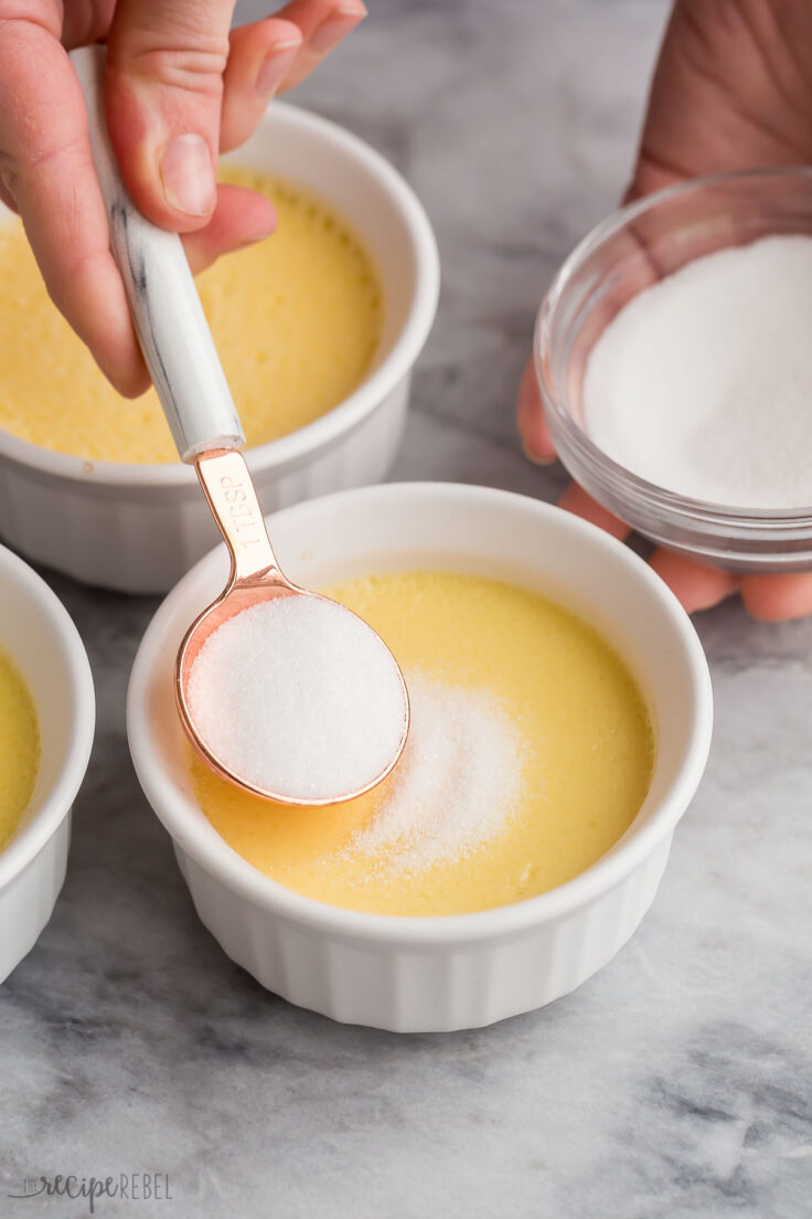 sugar being sprinkled on a cooled creme brulee