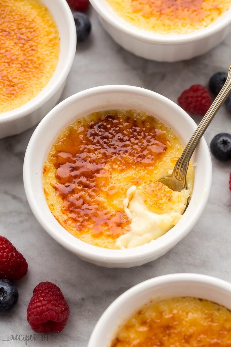 close up view of spoon scooping creme brulee