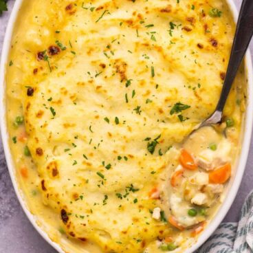 overhead image of creamy shepherd's pie in baking dish with spoon stuck in.