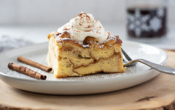 eggnog french toast casserole on a plate with whipped cream