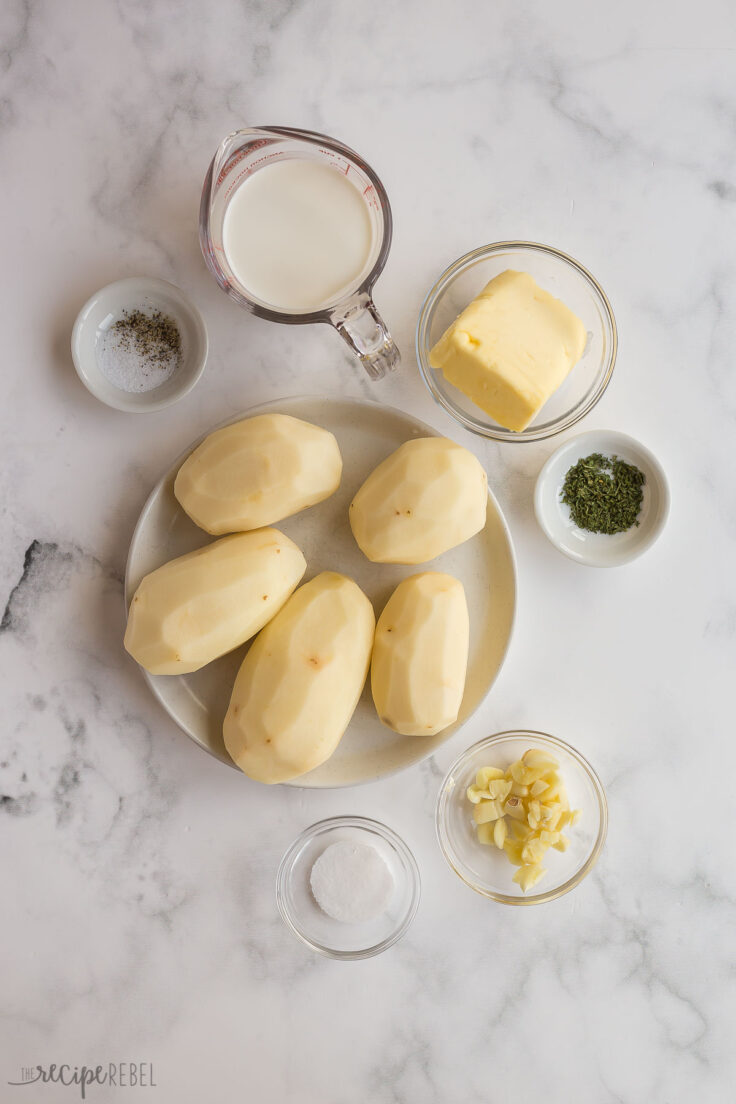 ingredients for garlic mashed potatoes on white background