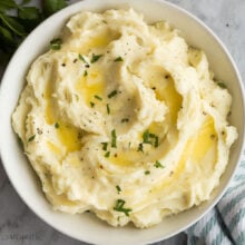 square overhead image of garlic mashed potatoes with melted butter