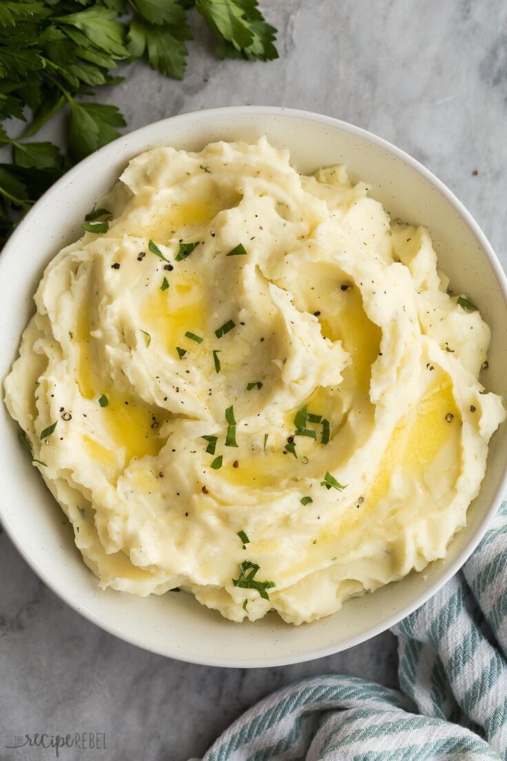 overhead image of garlic mashed potatoes with melted butter