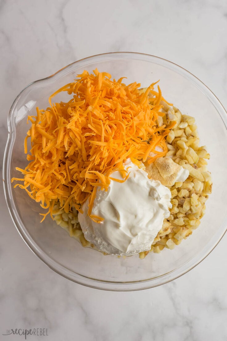 ingredients for hashbrown casserole in glass bowl