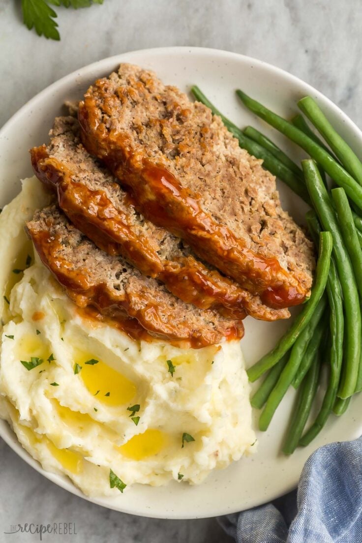 overhead image of three slices of instant pot meatloaf with mashed potatoes