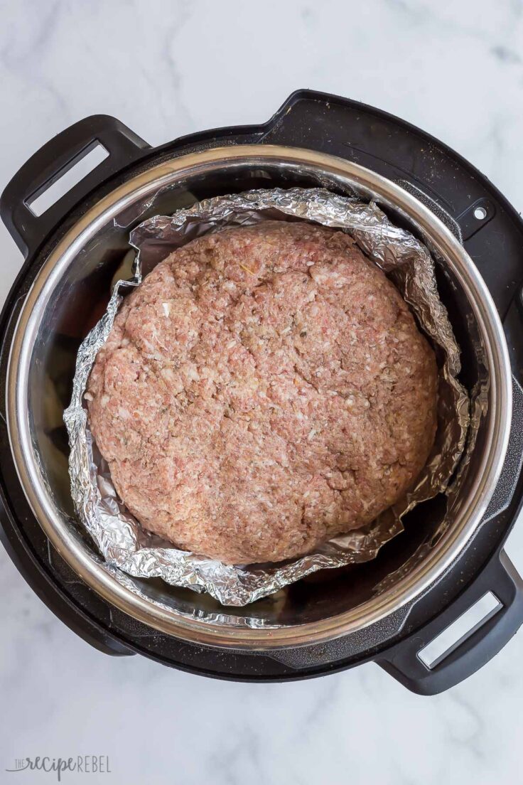 uncooked meatloaf in instant pot with foil underneath