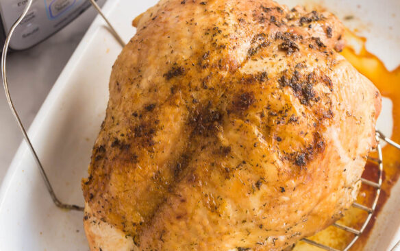 instant pot turkey breast in baking dish in front of pressure cooker