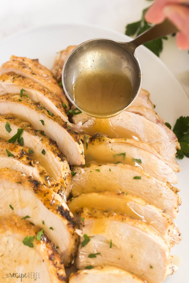 close up image of gravy being drizzled over instant pot turkey breast