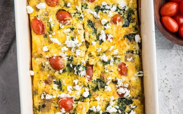 overhead image of mediterranean breakfast casserole in white and blue baking dish