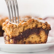 fork being stuck into piece of date coffee cake up close