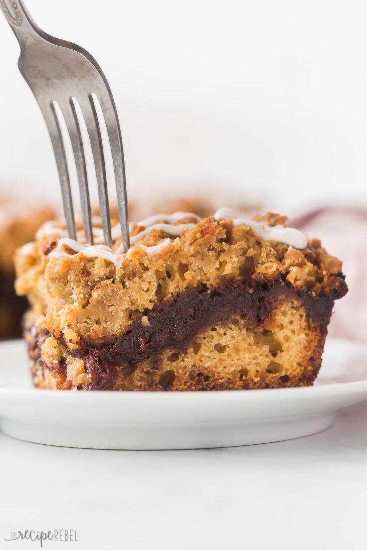 fork being stuck into piece of date coffee cake up close