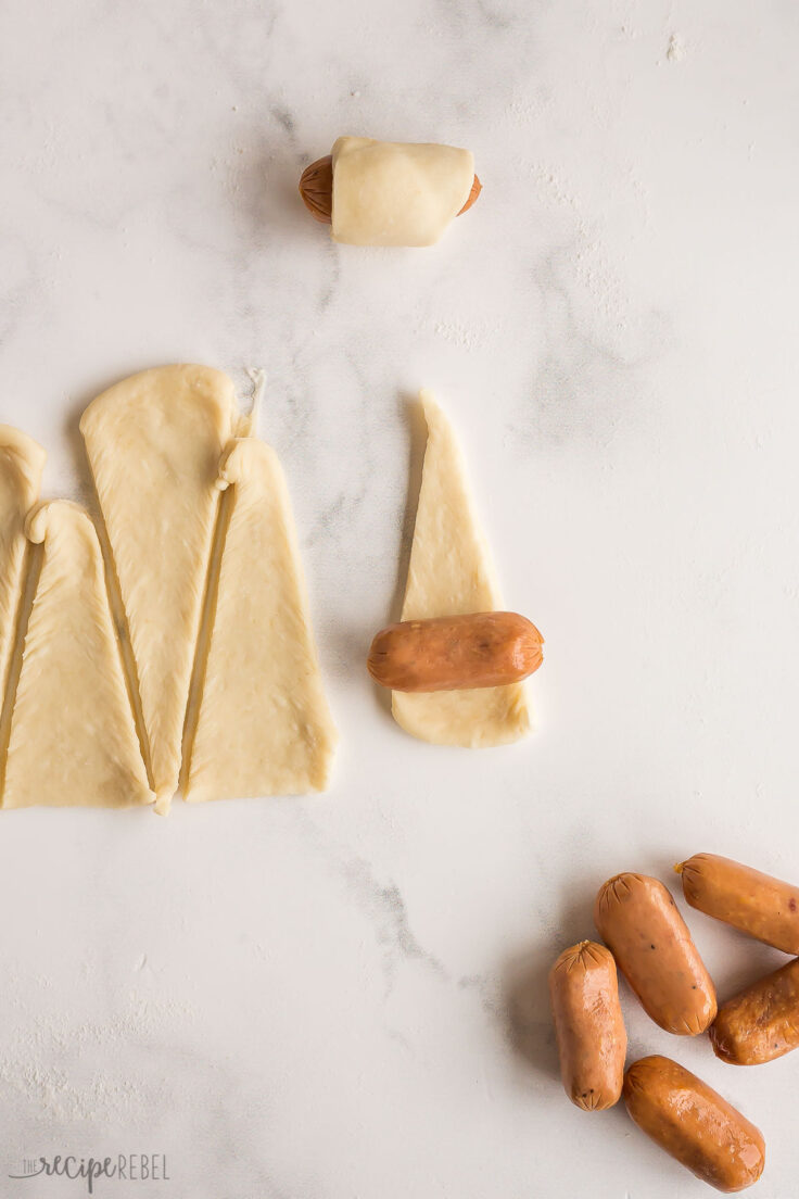 triangles of crescent dough with little smokies on ready to roll up