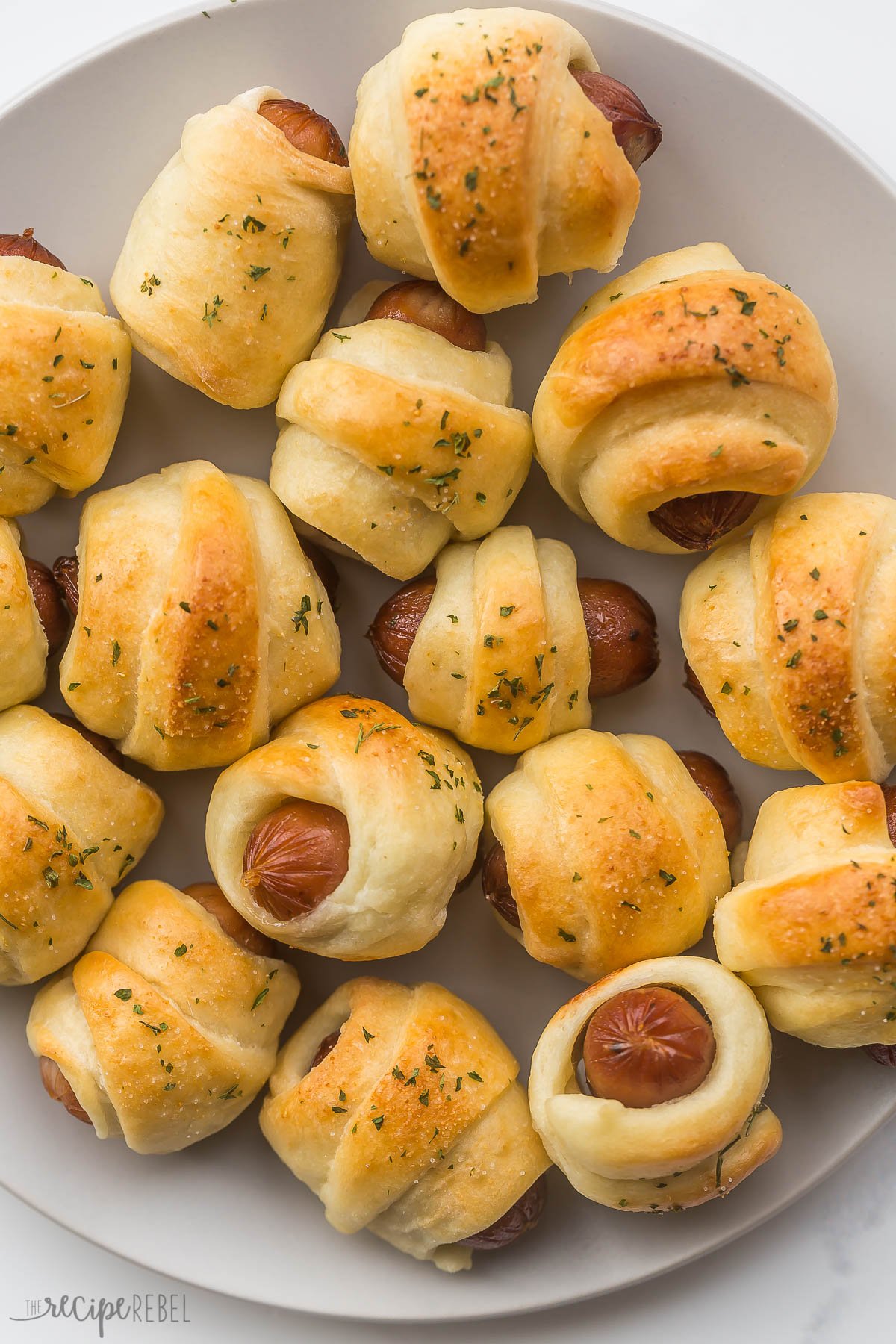 close up overhead image of pigs in a blanket on a plate