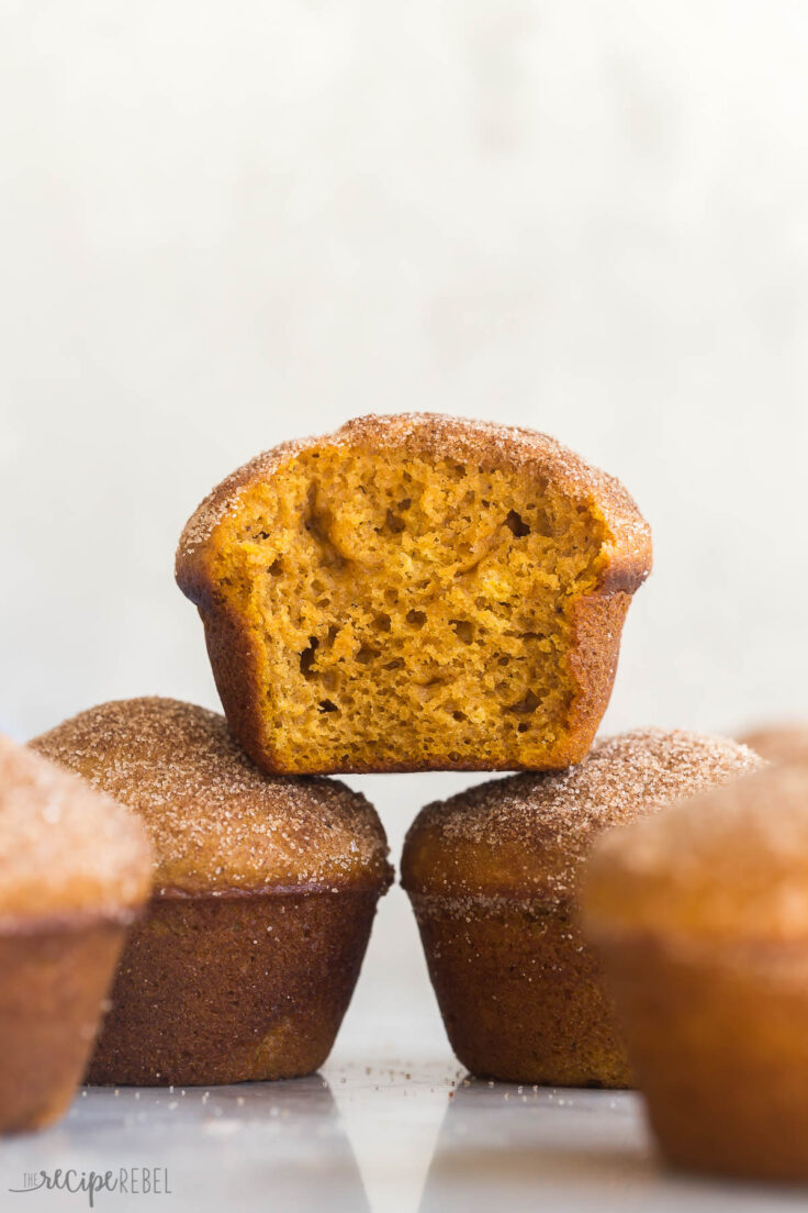 one pumpkin muffin stacked on top of two pumpkin muffins