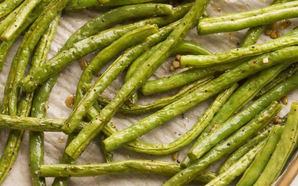 close up image of roasted green beans on baking sheet