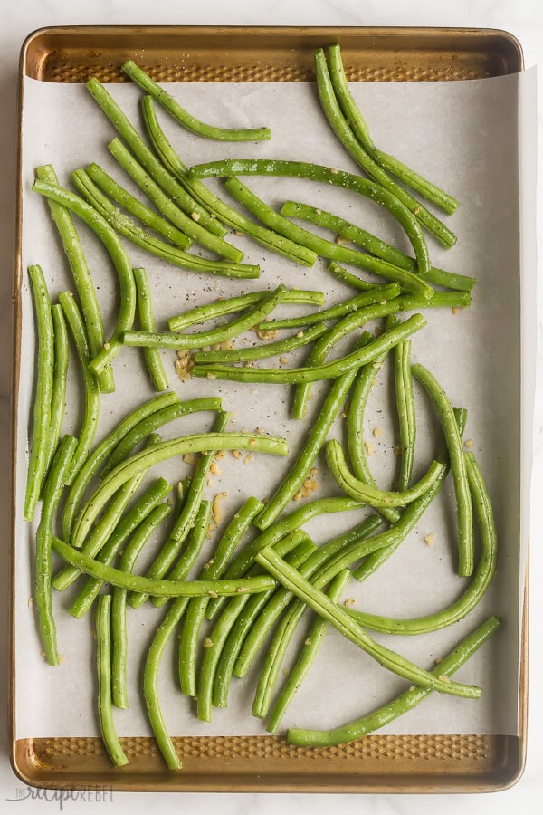 overhead image of green beans ready for roasting on baking sheet