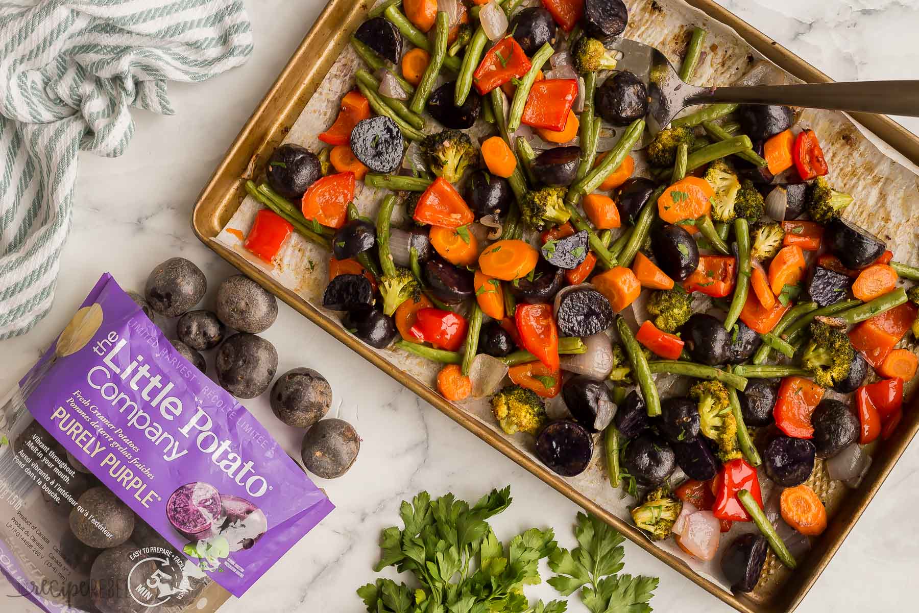 image of roasted vegetables with bag of purple potatoes