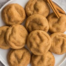 overhead image of snickerdoodle cookies on plate with cinnamon sticks