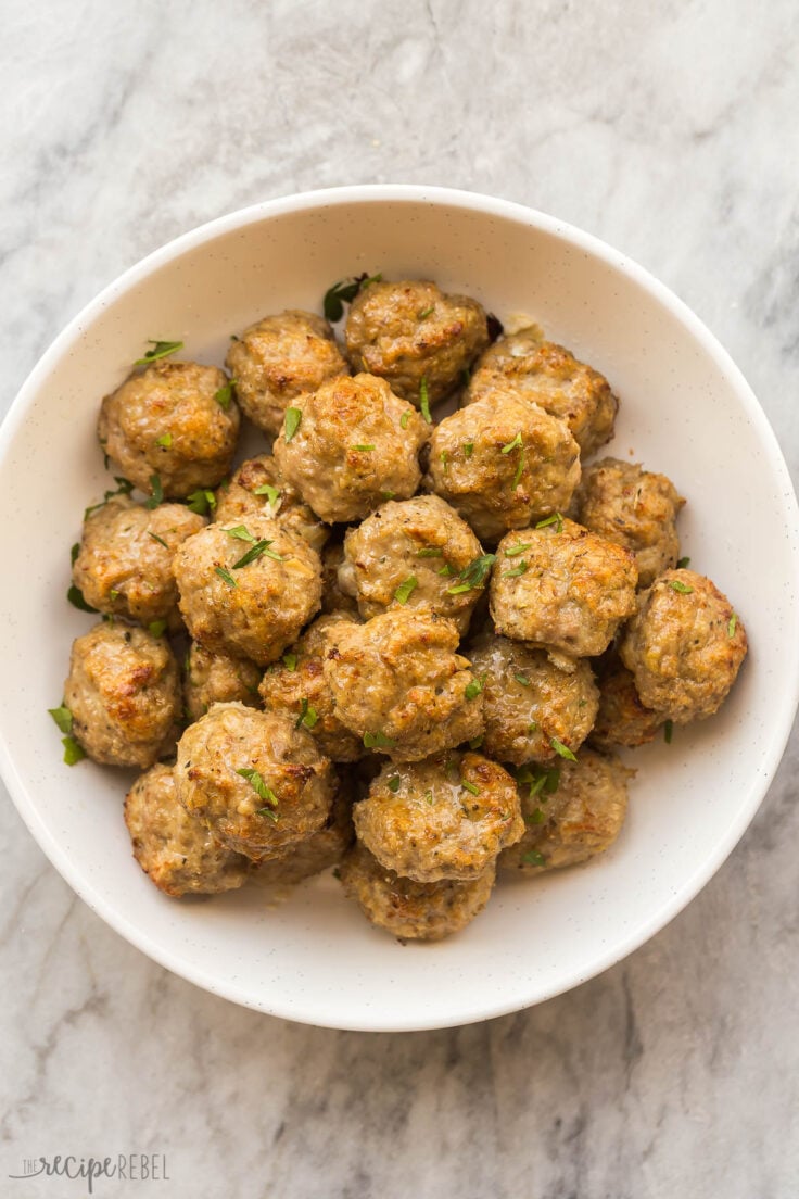 These baked Turkey Meatballs are tender in the middle and perfectly crispy on the outside. They're healthy, versatile, loaded with flavor, and come together in just 30 minutes! #turkey #dinner #recipes | easy dinner ideas | ground turkey recipes | baked meatballs | easy dinner ideas overhead image of baked turkey meatballs in bowl