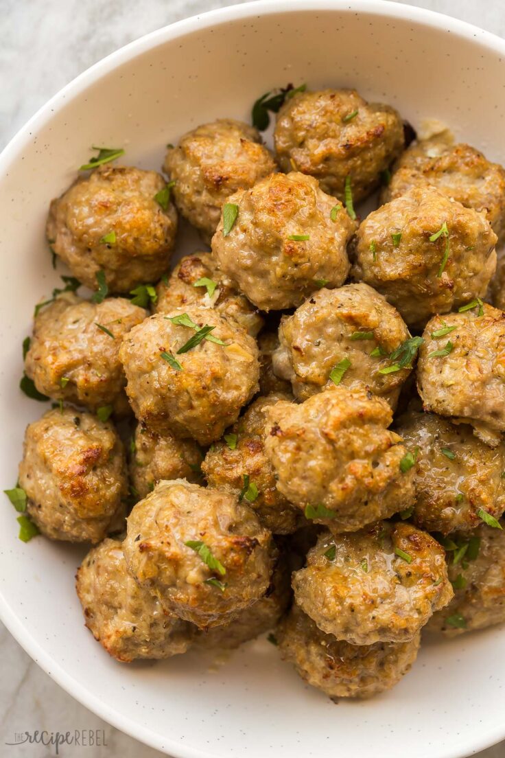 These baked Turkey Meatballs are tender in the middle and perfectly crispy on the outside. They're healthy, versatile, loaded with flavor, and come together in just 30 minutes! #turkey #dinner #recipes | easy dinner ideas | ground turkey recipes | baked meatballs | easy dinner ideas close up image of turkey meatballs in large bowl