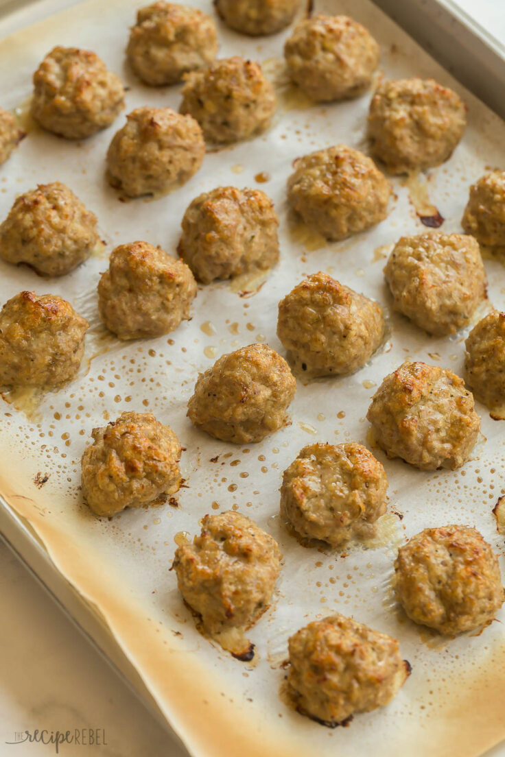 These baked Turkey Meatballs are tender in the middle and perfectly crispy on the outside. They're healthy, versatile, loaded with flavor, and come together in just 30 minutes! #turkey #dinner #recipes | easy dinner ideas | ground turkey recipes | baked meatballs | easy dinner ideas turkey meatballs on baking sheet after cooking
