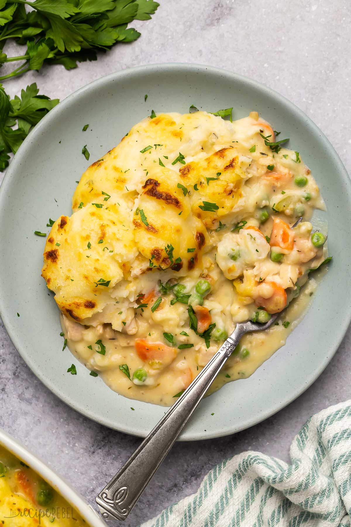 overhead image of leftover turkey shepherd's pie on grey plate with fork.