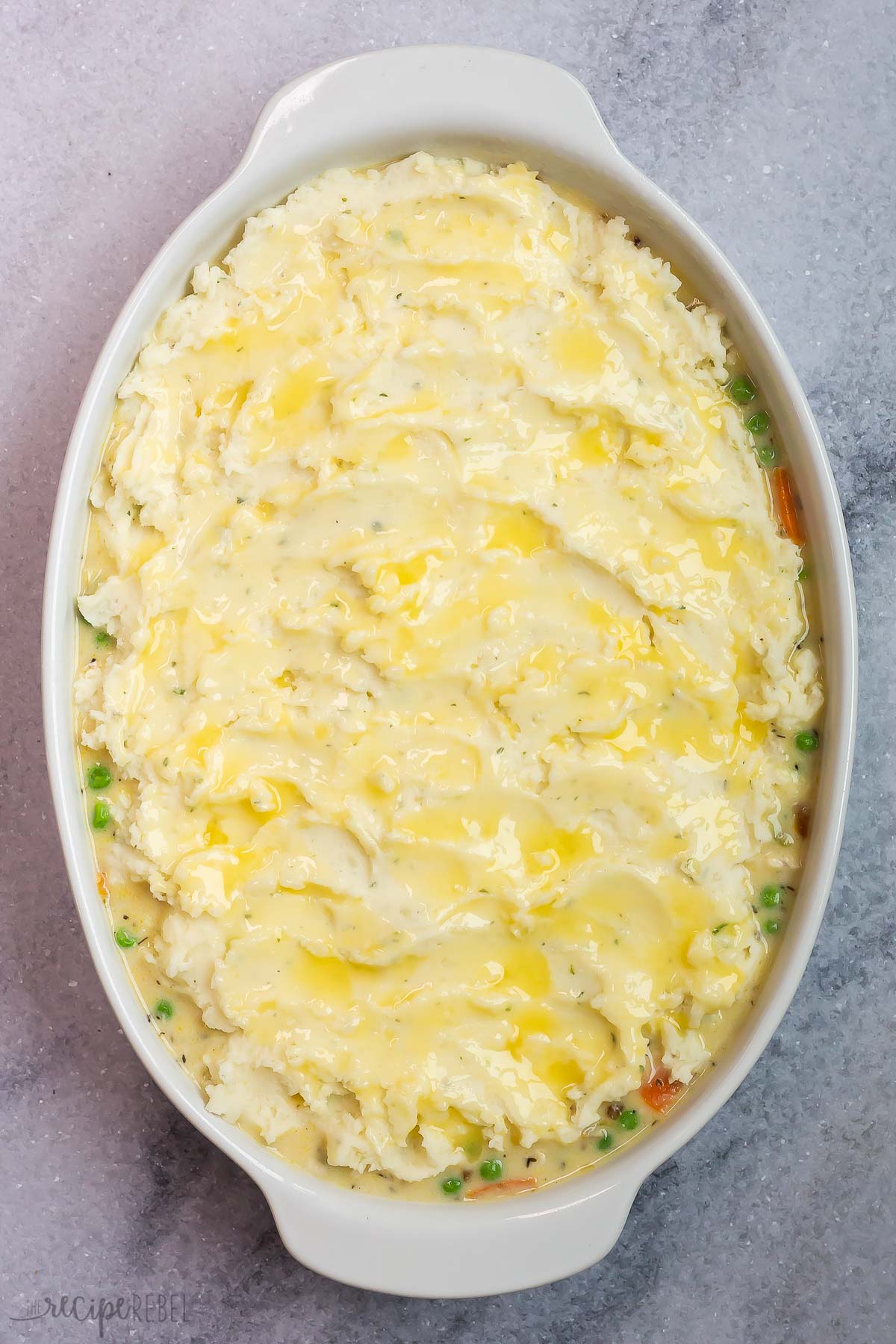 melted butter brushed over mashed potatoes on shepherd's pie.