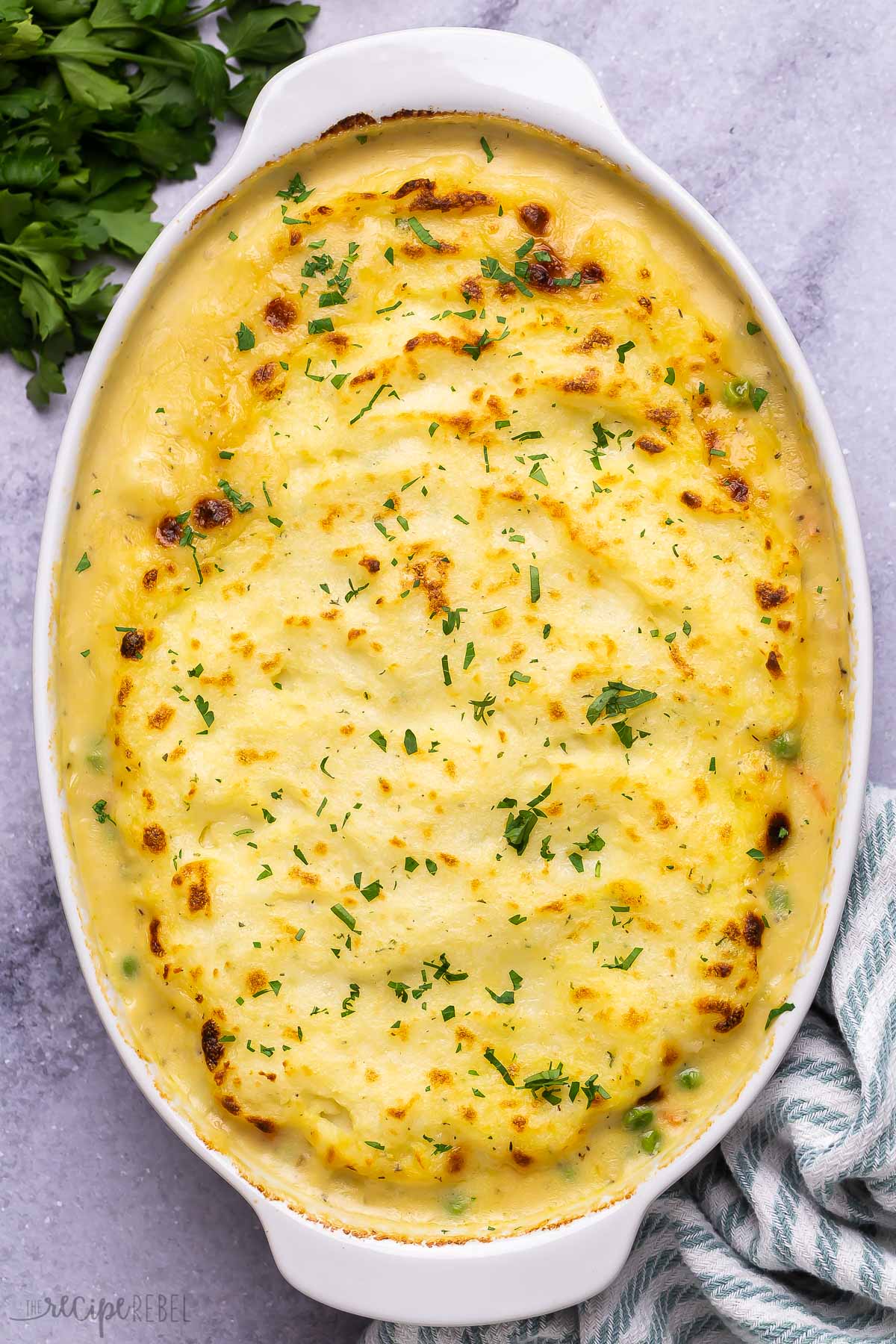 baked shepherd's pie with golden mashed potatoes in baking dish.