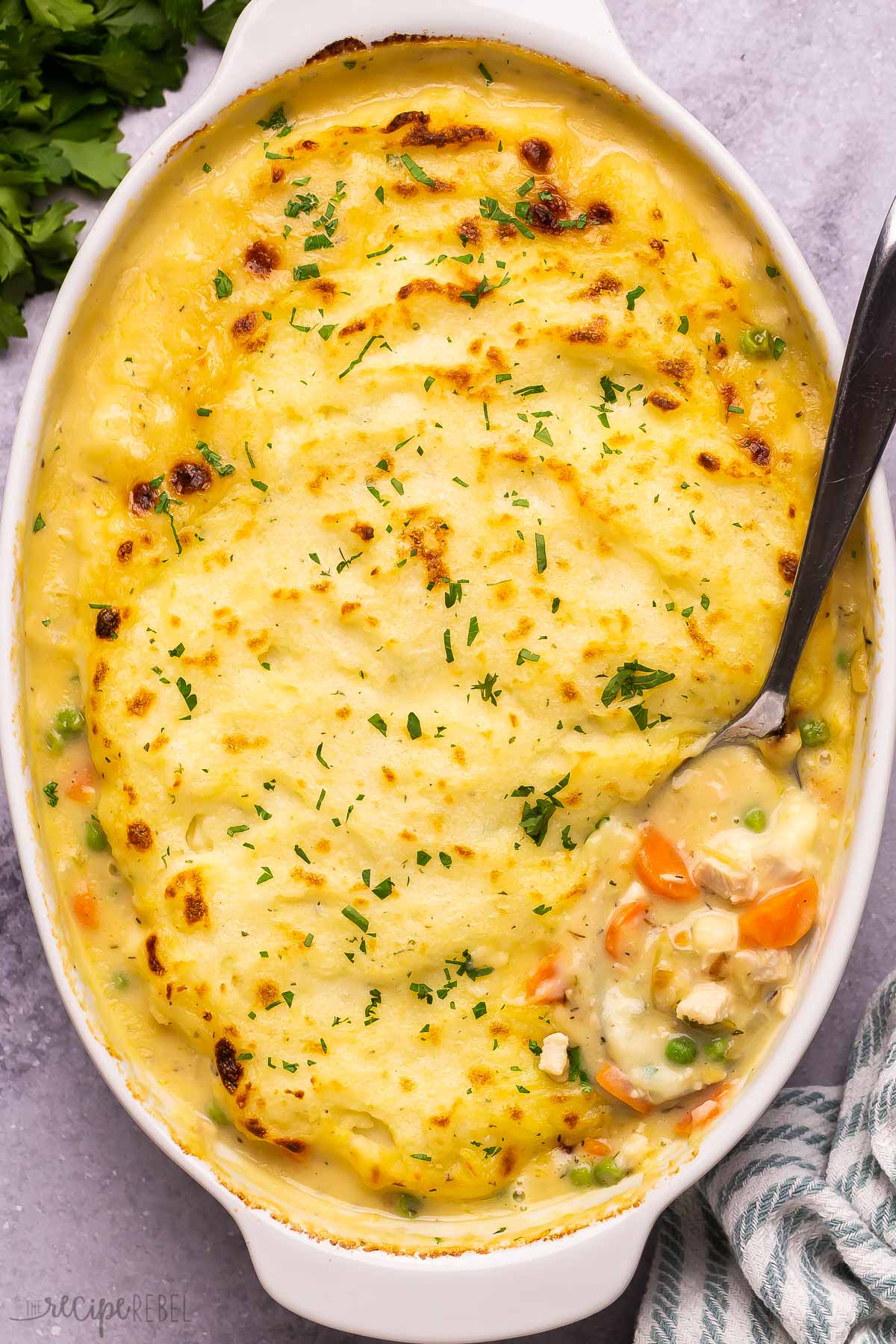 overhead image of creamy shepherd's pie in baking dish with spoon stuck in.