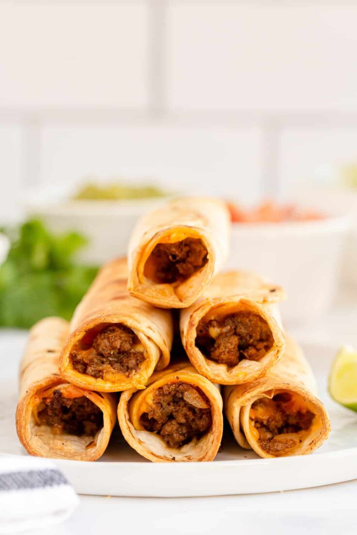 tall stack of air fryer beef taquitos on plate