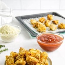 air fryer fish nuggets in bowl with sauce in the background