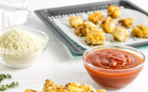 air fryer fish nuggets in bowl with sauce in the background