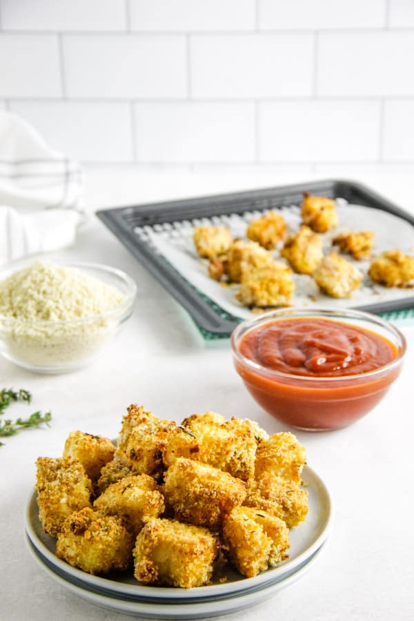 air fryer fish nuggets in bowl with sauce in the background