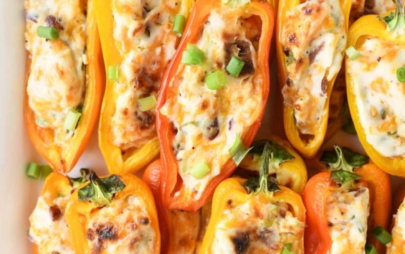 Overhead view of stuffed mini peppers on a tray