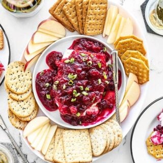 Overhead view of cranberry dip on a platter with crackers and apple slices