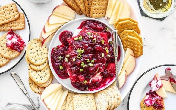Overhead view of cranberry dip on a platter with crackers and apple slices