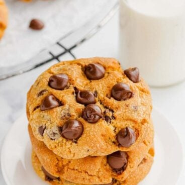 stack of air fryer chocolate chip cookies with milk on the side