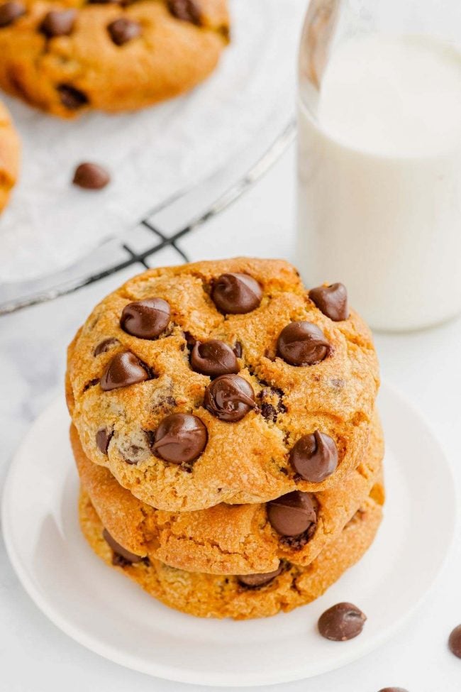 stack of air fryer chocolate chip cookies with milk on the side