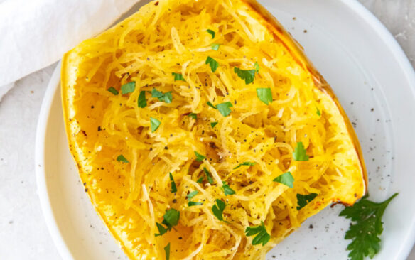 air fryer spaghetti squash cut in half on white plate