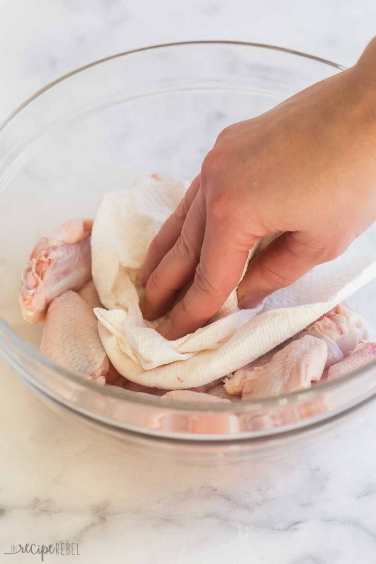 drying uncooked chicken wings with paper towel
