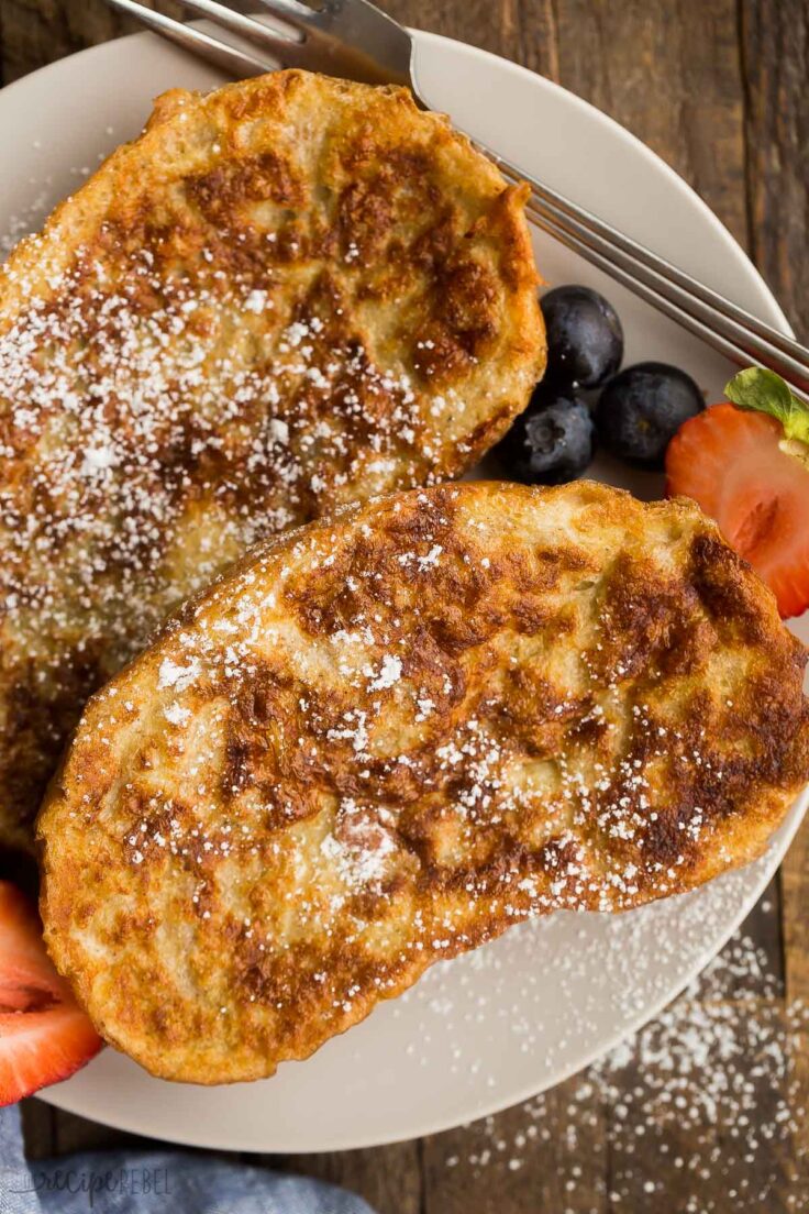 close up image of two slices of french toast with dusting of powdered sugar