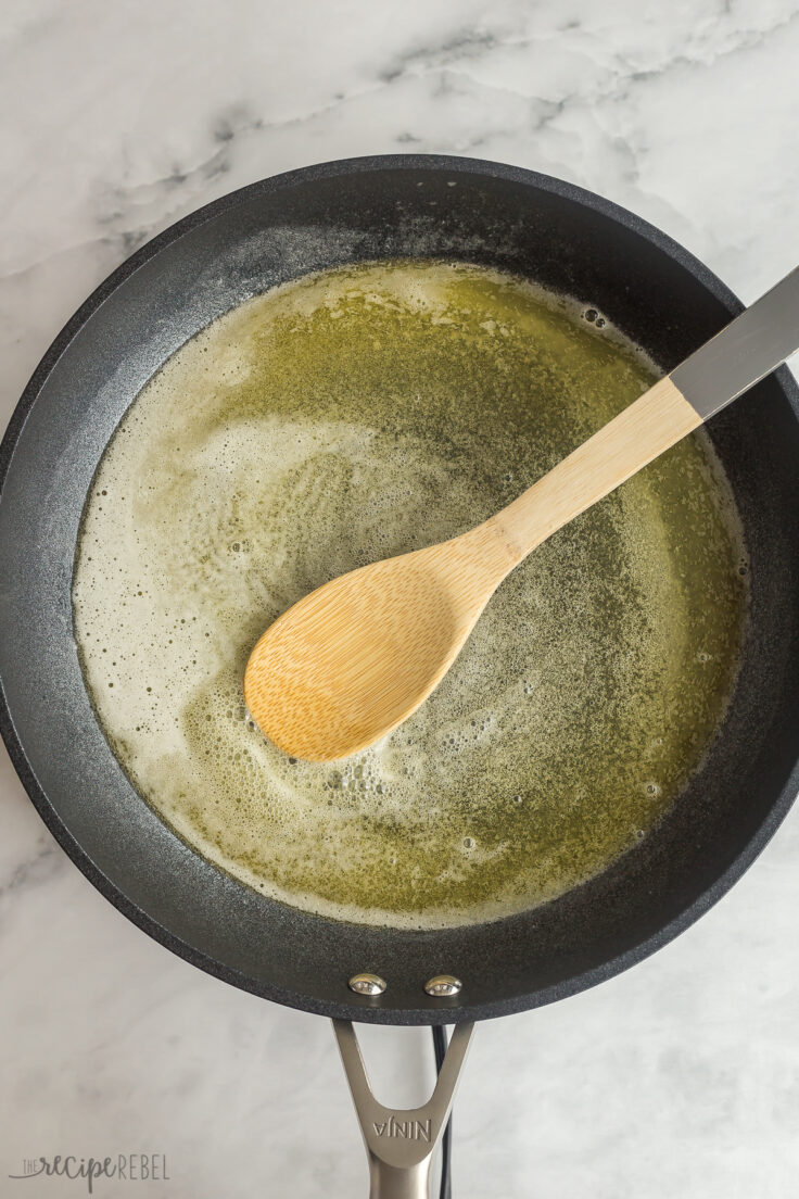 melted butter in skillet with wooden spoon