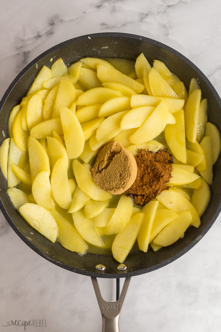 softened apple slices in skillet with brown sugar and cinnamon added