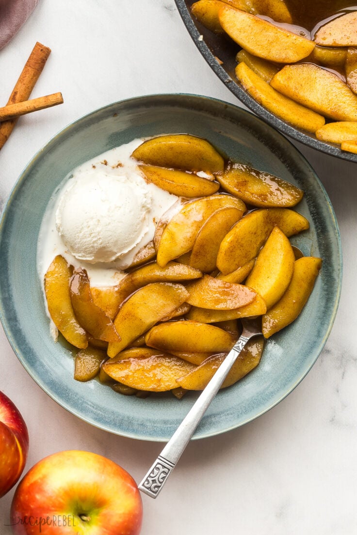 fried apples in a bowl with one scoop of vanilla ice cream