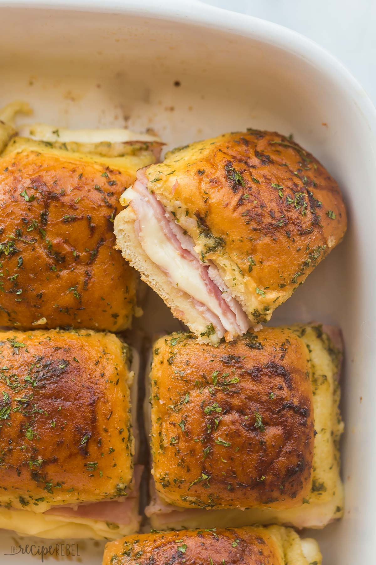 close up of one slider bun cut from whole in baking dish