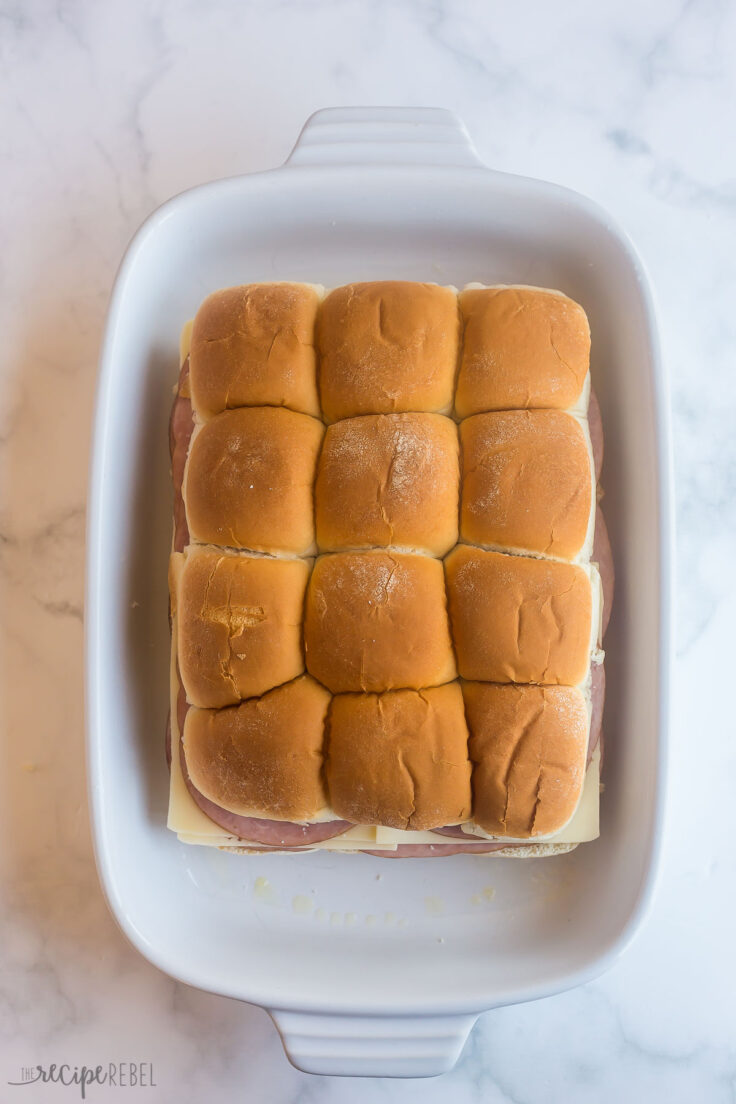 ham and cheese sliders prep with top buns on in baking dish